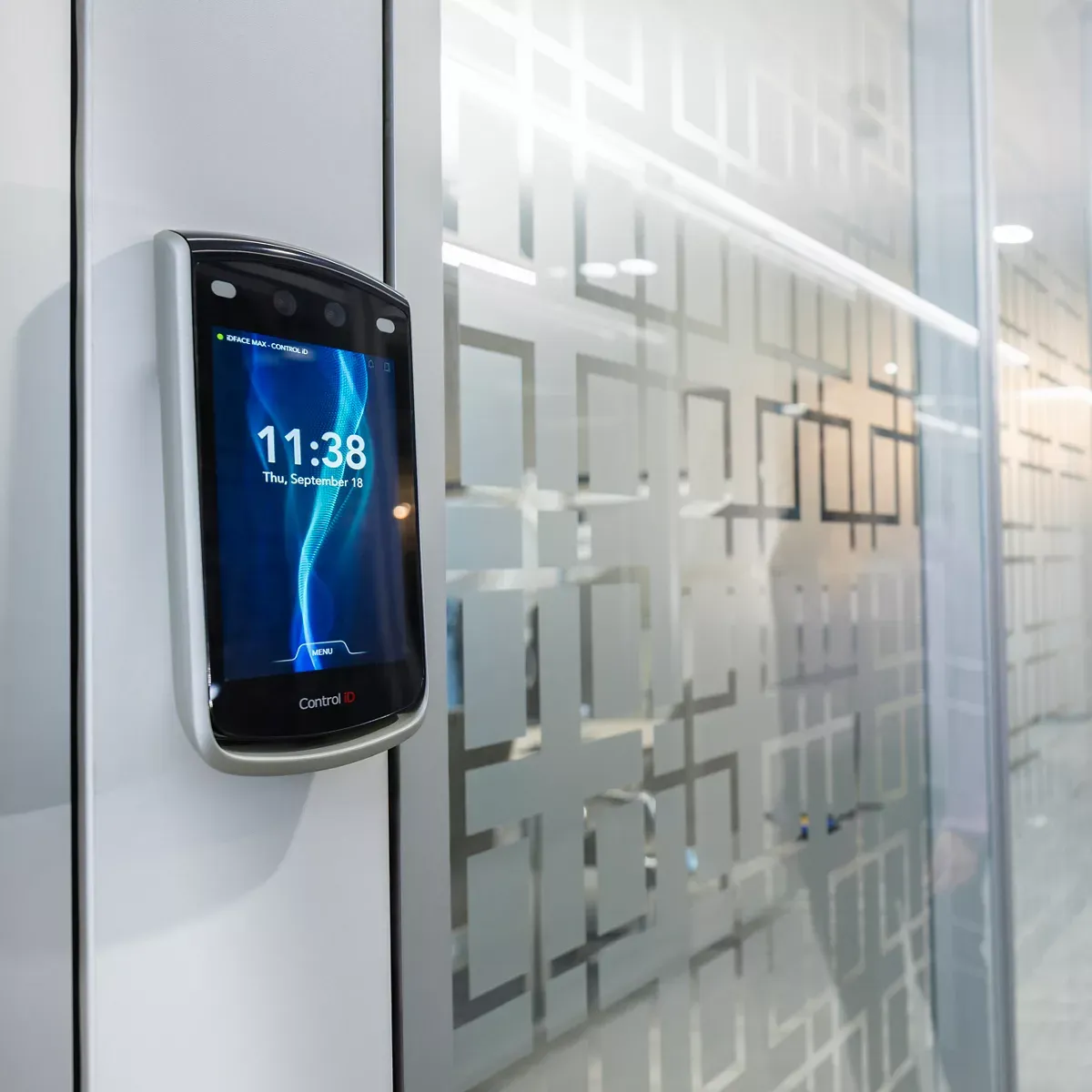 iDFace Max mounted beside a glass meeting room door